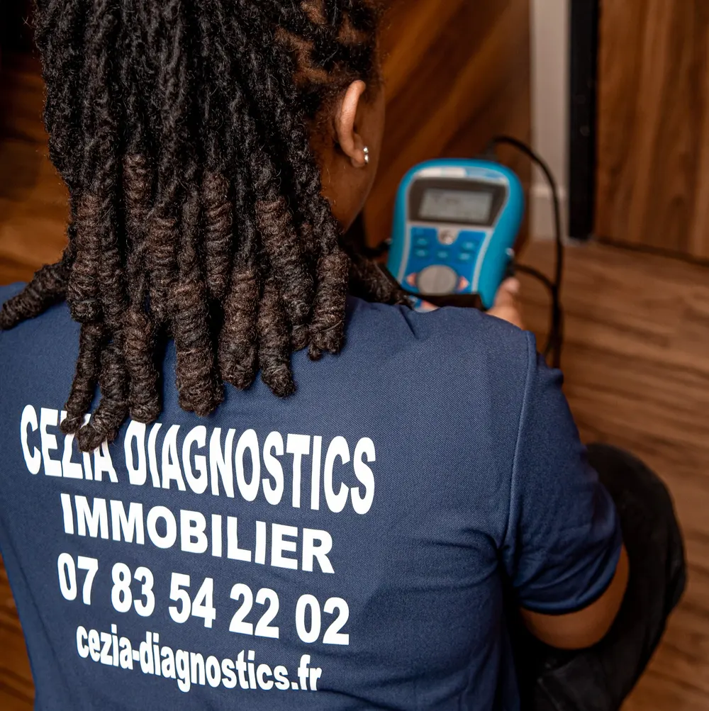 La diagnostiqueuse, de dos en polo Cezia Diagnostics, teste une installation électrique avec un appareil de mesure
